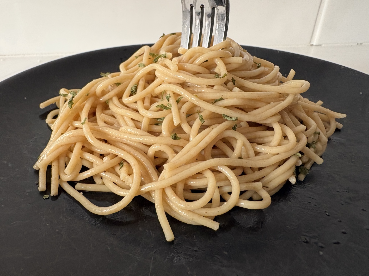 Close-up of whole grain pasta with olive oil and herbs